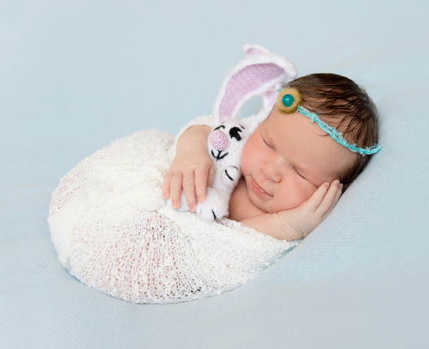 wrapped newborn with toy sleeping - Zdjęcie, obraz