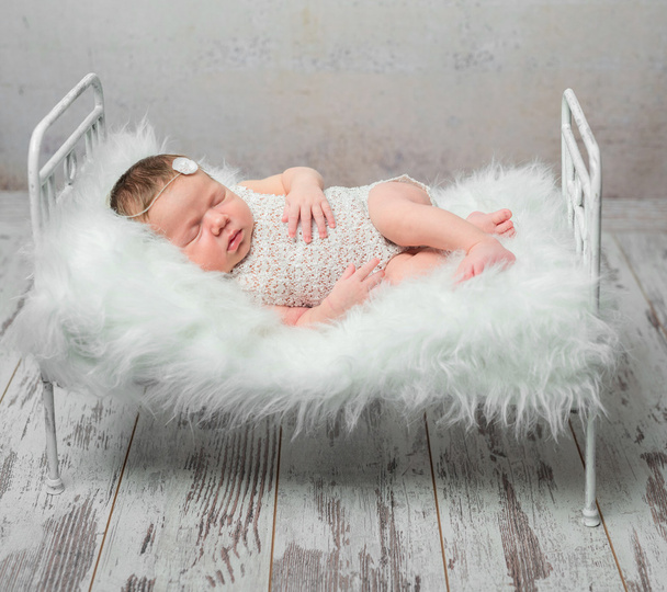cute sleeping newborn baby on cot - Foto, Imagem