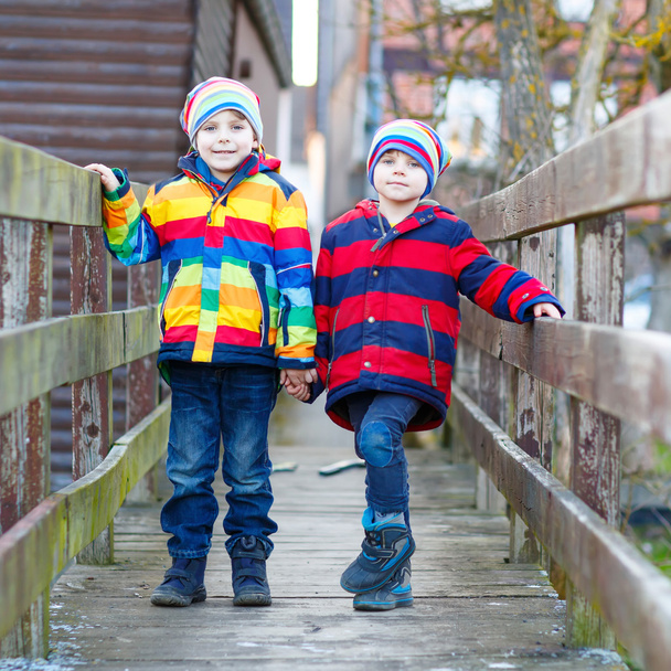 Two little kid boys outdoors in spring town - Fotoğraf, Görsel