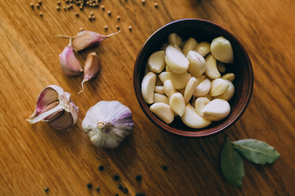 Bowl of garlic on wooden table - Photo, Image