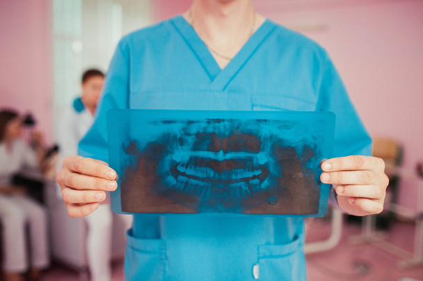 doctor sosteniendo rayos X de mandíbulas humanas
 - Foto, imagen