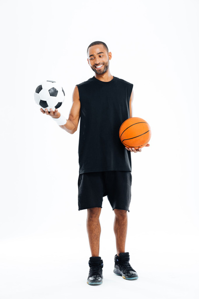 Portrait of a smiling sports man looking at soccer ball - Fotoğraf, Görsel