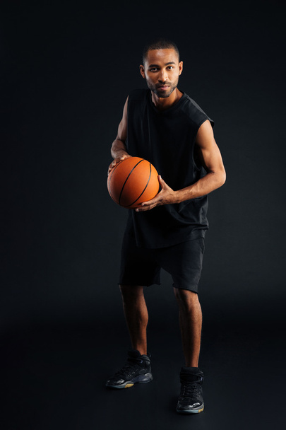 Full length portrait of a serious african sportsman playing basketball - Φωτογραφία, εικόνα