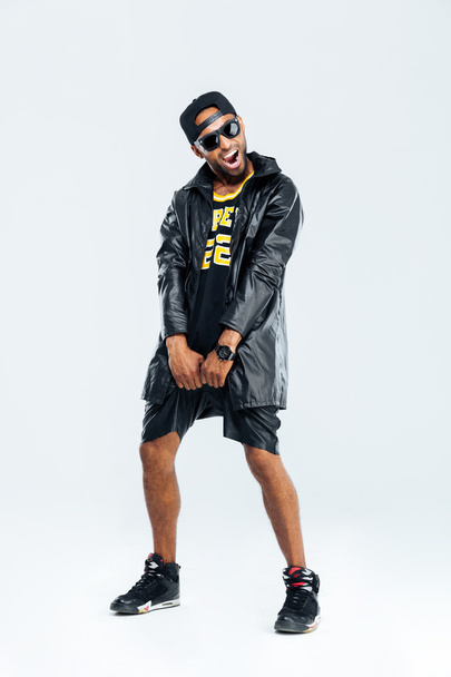 Cheerful afro american man in trendy cloth posing - Фото, изображение