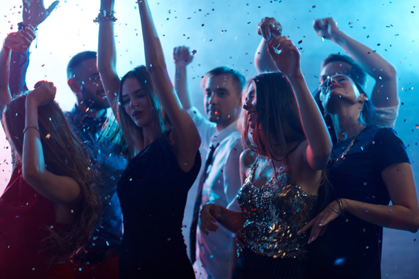 Ecstatic people dancing in night club  - Photo, Image