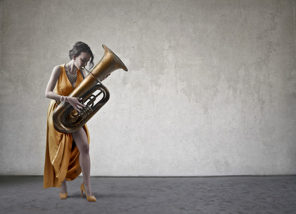 woman is playing one instrument - Zdjęcie, obraz