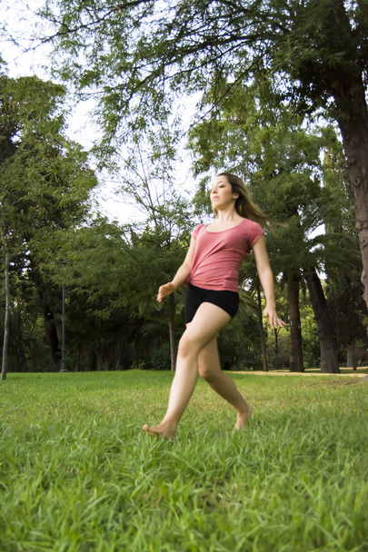Beautiful ballerina doing exercises for dancing outdoors - Foto, immagini
