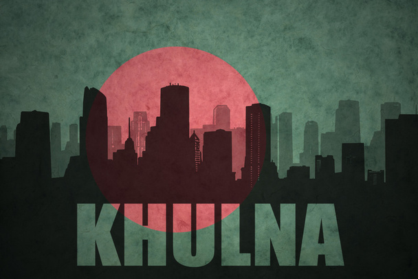 abstract silhouette of the city with text Khulna at the vintage bangladesh flag background - Photo, Image