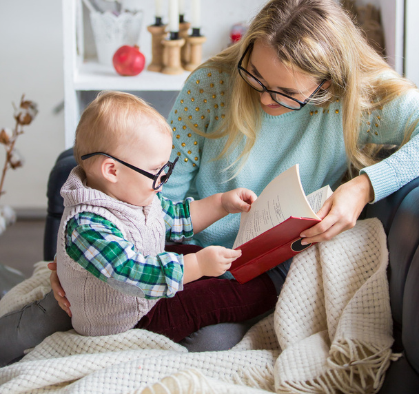Mother and her son reading book at home - 写真・画像