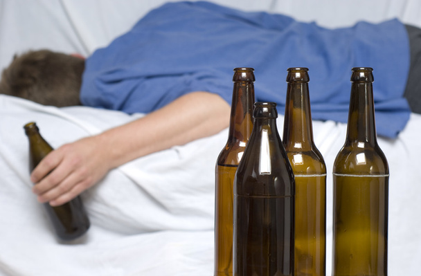 Man passed out with a beer bottle in his hand - Photo, Image