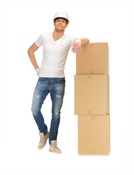 Handsome builder with big boxes - 写真・画像
