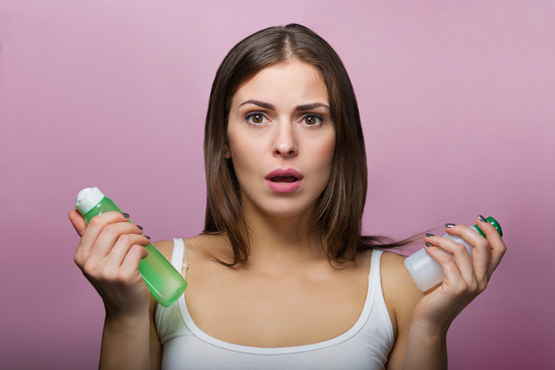 Pretty woman choosing a skin care product - Фото, зображення