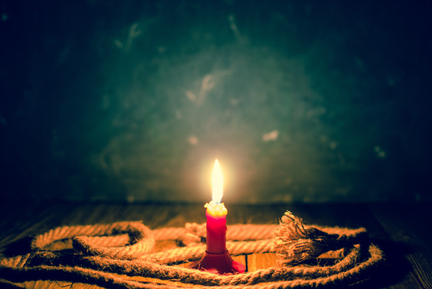 Burning candle on a table. - Foto, Imagen