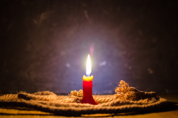 Burning candle on a table. - Fotó, kép