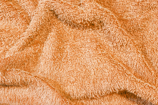 Closeup surface fabric pattern at old and wrinkled orange fabric towel texture background - Photo, Image