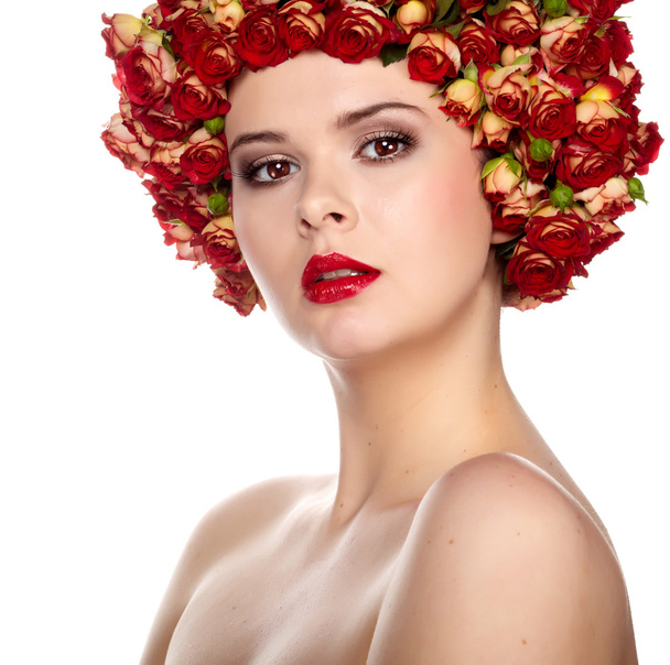 Portrait of young beautiful woman with roses in hair, on white b - 写真・画像