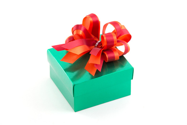 Green gift box with red satin bow isolated on white background - Photo, image