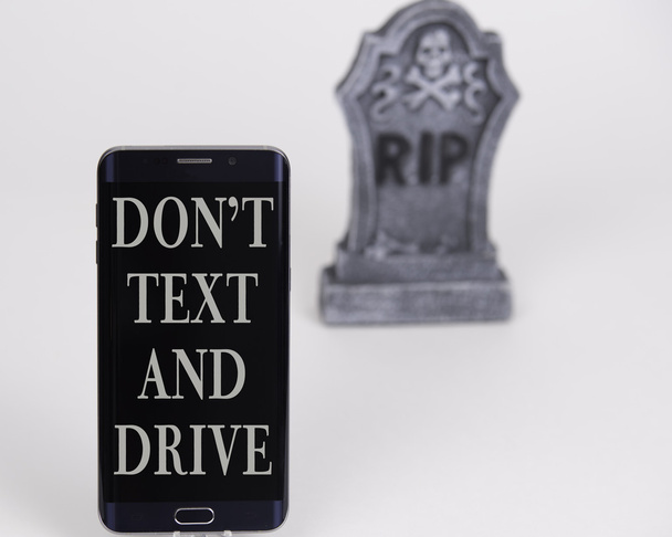 Dont text and drive phone with headstone, and white background - Photo, Image