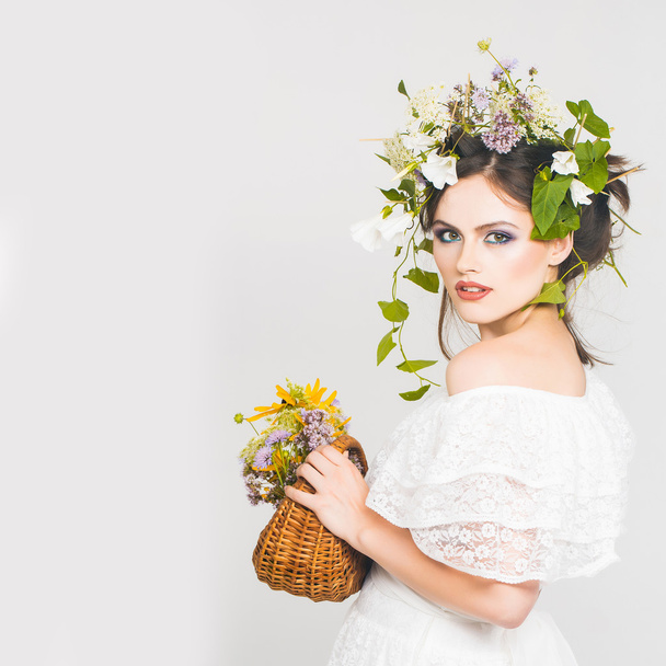 young pretty girl with flower wreath - Fotó, kép