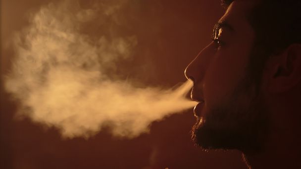 man breathes out smoke - Photo, Image
