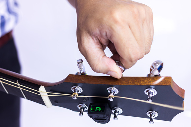 Person tuning a guitar - Photo, Image