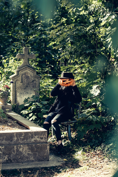 halloween woman with pumpkin on tomb - Fotó, kép