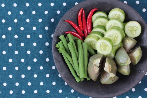 Mixed vegetable is side dish of spicy sauce in organic Asian cuisine as streamed eggplant,sliced cucumber,  lentils and red chili. Have text space on left.  - Valokuva, kuva