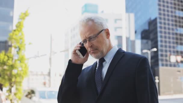 senior businessman calling on smartphone in city - Кадры, видео