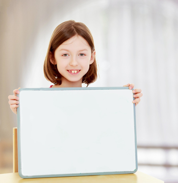 Little girl holding white poster. - Fotó, kép