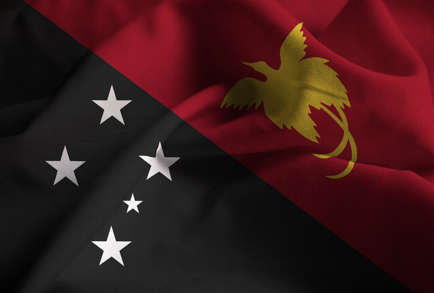 Nahaufnahme von geraffter Papua-Neuguinea-Flagge, Papua-Neuguinea-Flagge  - Foto, Bild