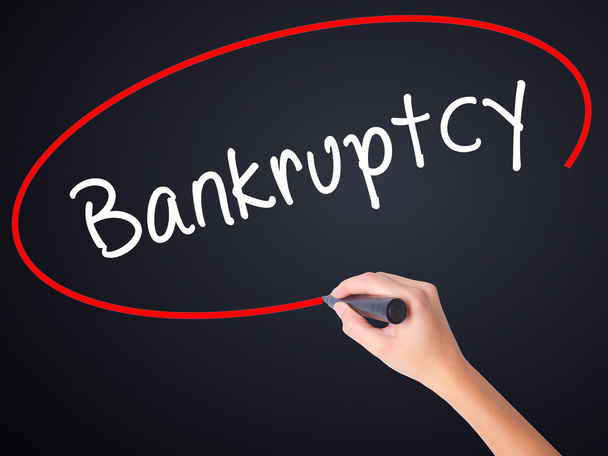 Woman Hand Writing Bankruptcy with a marker over transparent boa - Photo, Image
