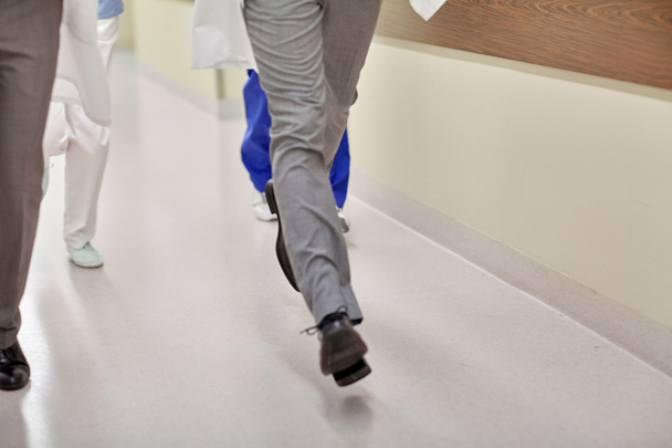 close up of medics or doctors running at hospital - Фото, изображение