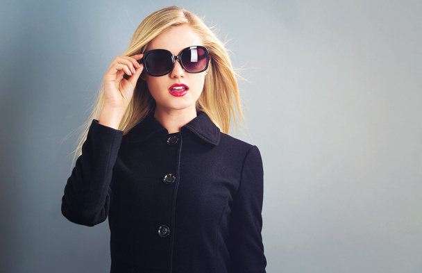 blonde woman in black coat - Foto, Imagen