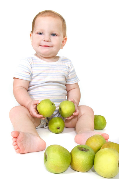 baby with green apples over white - Фото, изображение