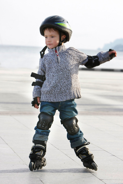 Fiatal fiú görgő pengék szabadtéri portréja - Fotó, kép