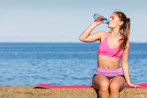 Woman drinking water after sport gym outdoor - Фото, изображение
