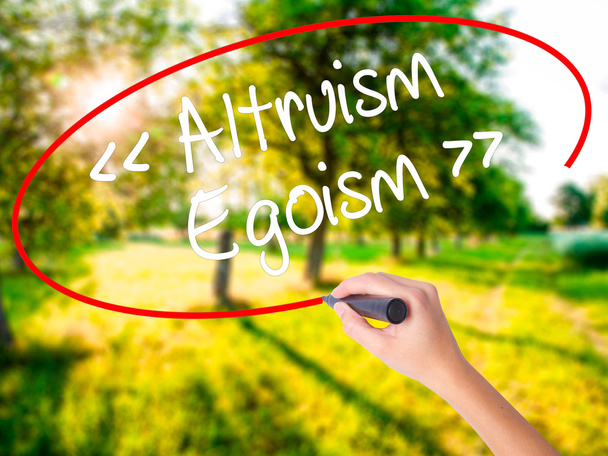 Woman Hand Writing Altruism - Egoism with a marker over transpar - Photo, Image