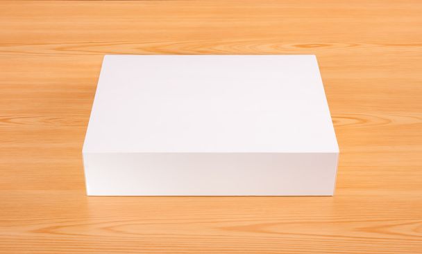 Lege witte doos mock up op hout achtergrond - Foto, afbeelding