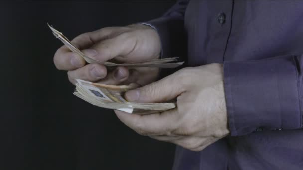 Man counts money in hands - Materiał filmowy, wideo