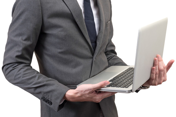 Businessman holding laptop isolated on white background. - Foto, imagen