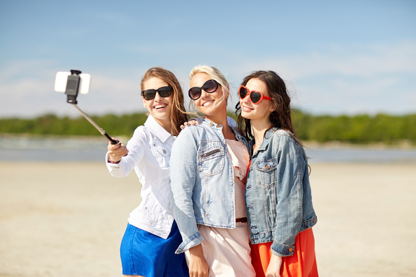 group of smiling women taking selfie on beach - Photo, image