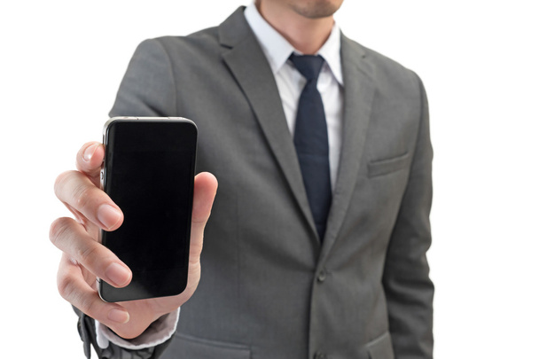Uomo d'affari in possesso di telefono cellulare isolato su sfondo bianco
. - Foto, immagini