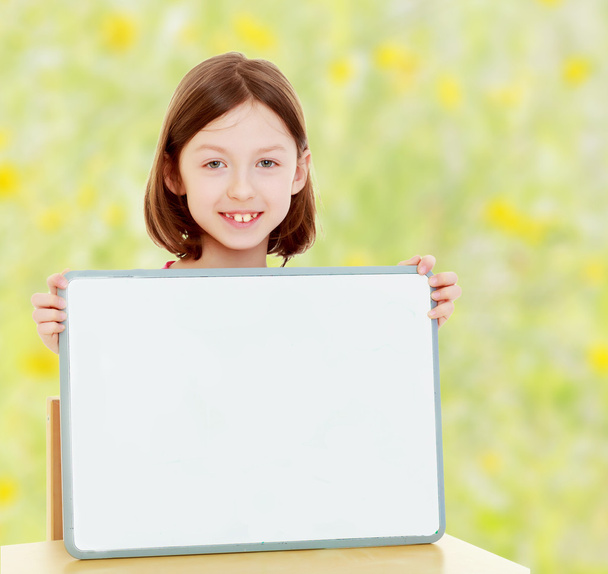 Little girl holding white poster. - Photo, Image
