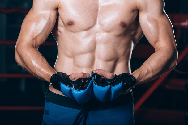 Muscular Fighter kickbox With blue gloves - Valokuva, kuva