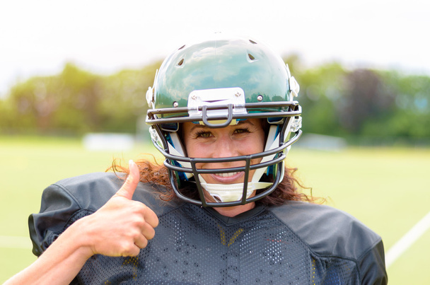 Motivated young female American football player - Photo, Image