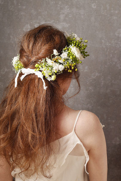 Woman wearing wedding wreath. Flower wreath with carnations - Фото, изображение