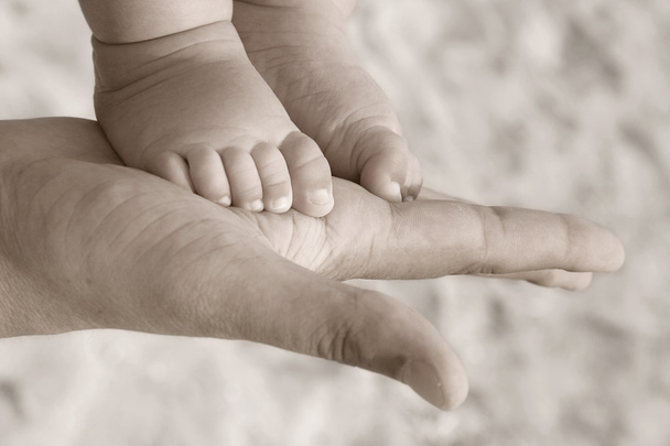 baby foot on parent hand - Photo, Image