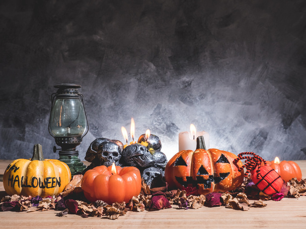 Halloween pumpkins with candlelight and skulls on dark background - Photo, Image