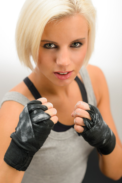 Woman ready to fight with kickbox gloves - 写真・画像