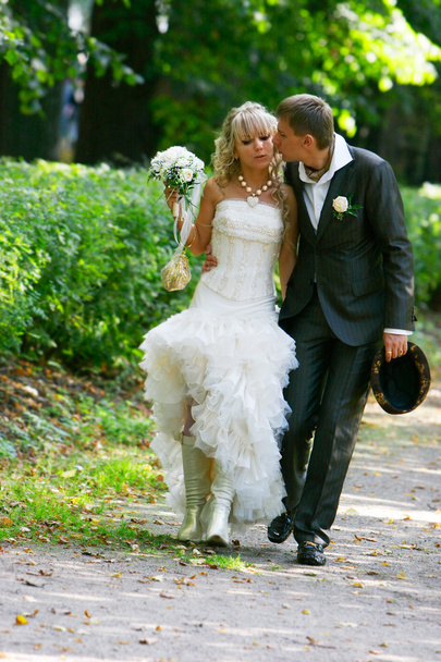 Loving couple on their wedding day in autumn park - Photo, Image